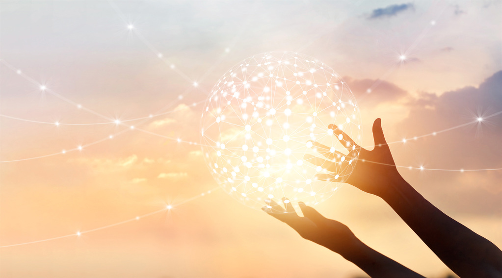 hands raised into the sunset on a cloudy day