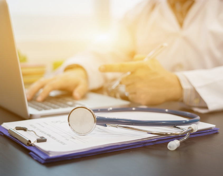 doctors stethescope on the table near their laptop